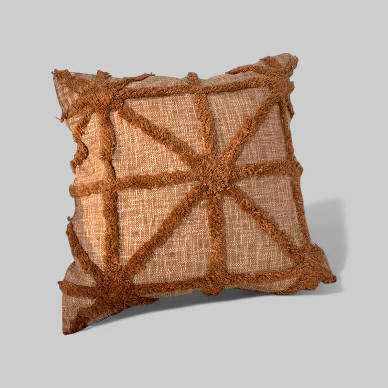 Brown tufted geometric cushion cover shown against a plain grey background