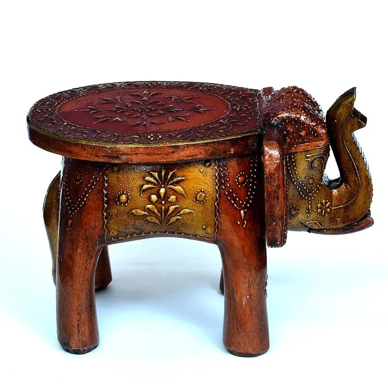 Side view of brown carved wooden stool with carved detailing