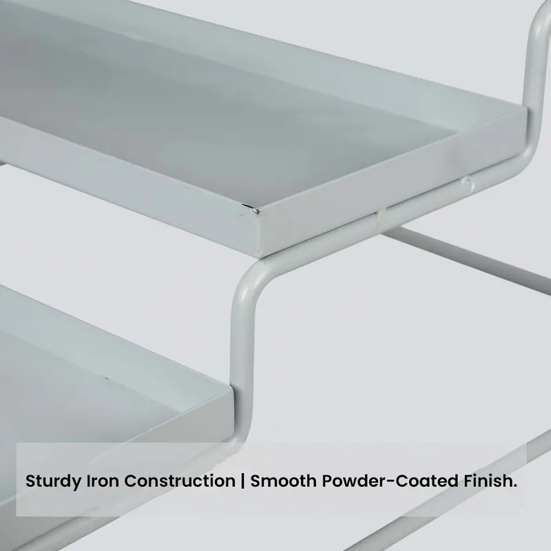 Close-up of the white metal organiser showing tiered trays and metal frame