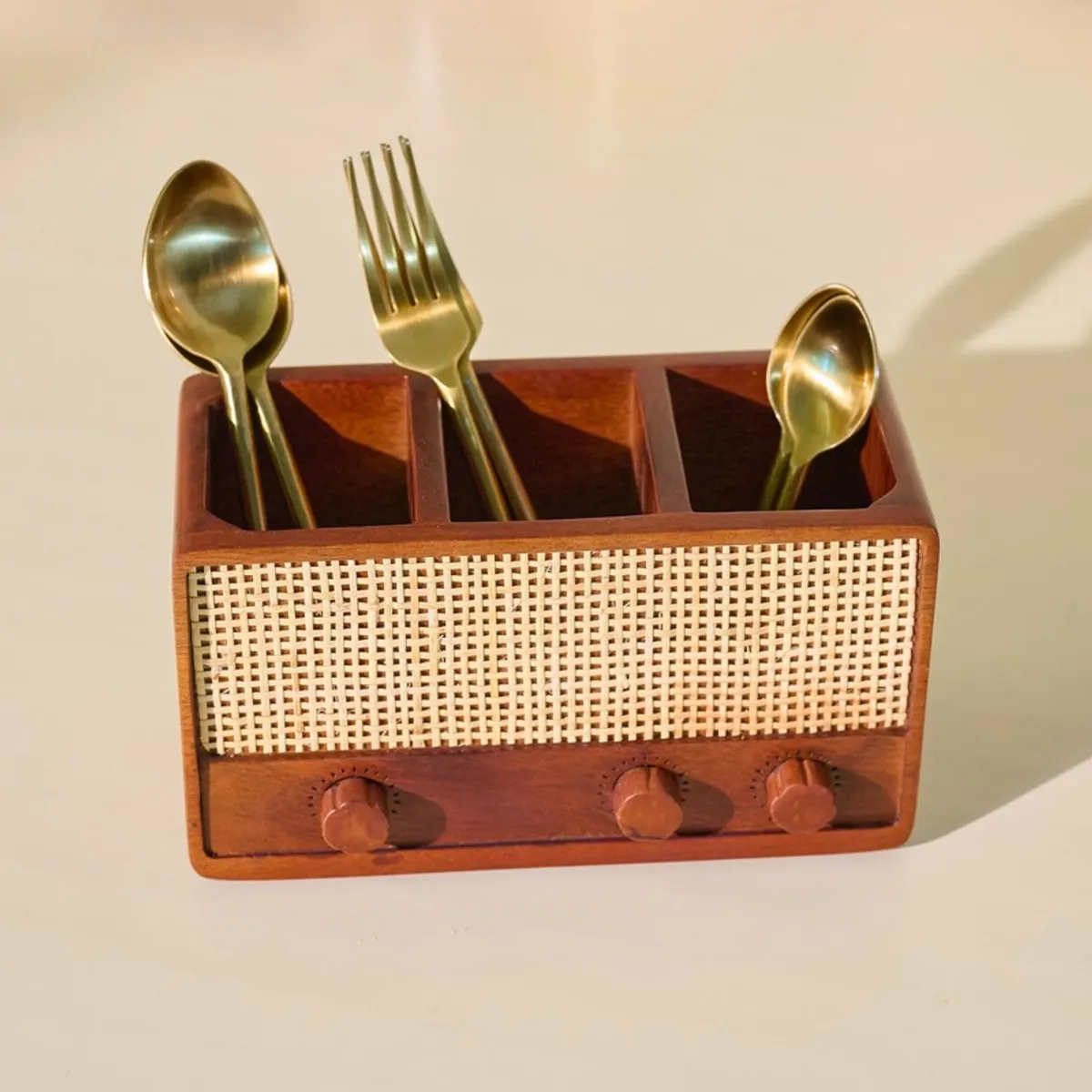 Front view of brown wooden cutlery stand with three open sections