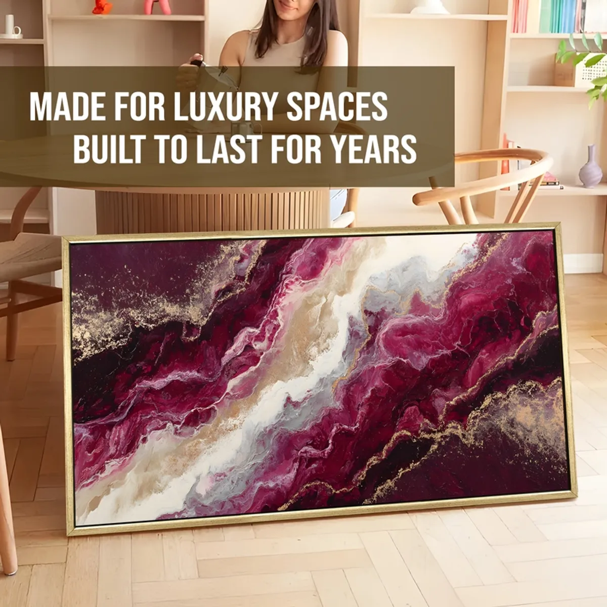 Framed abstract canvas painting leaning on the floor in a styled room