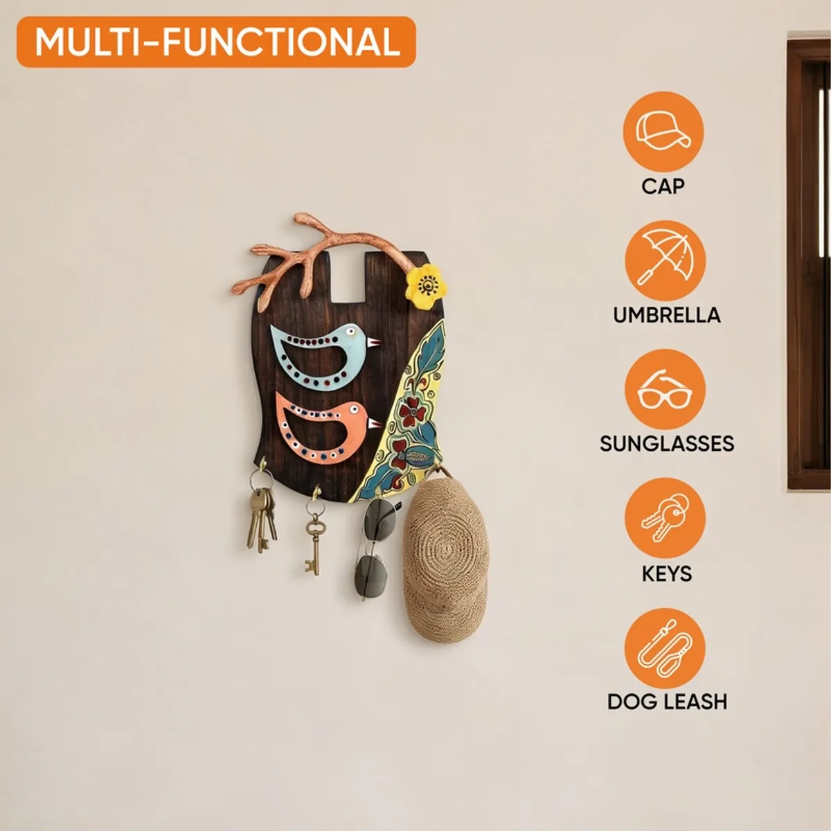 Decorative bird key holder shown holding keys and everyday accessories