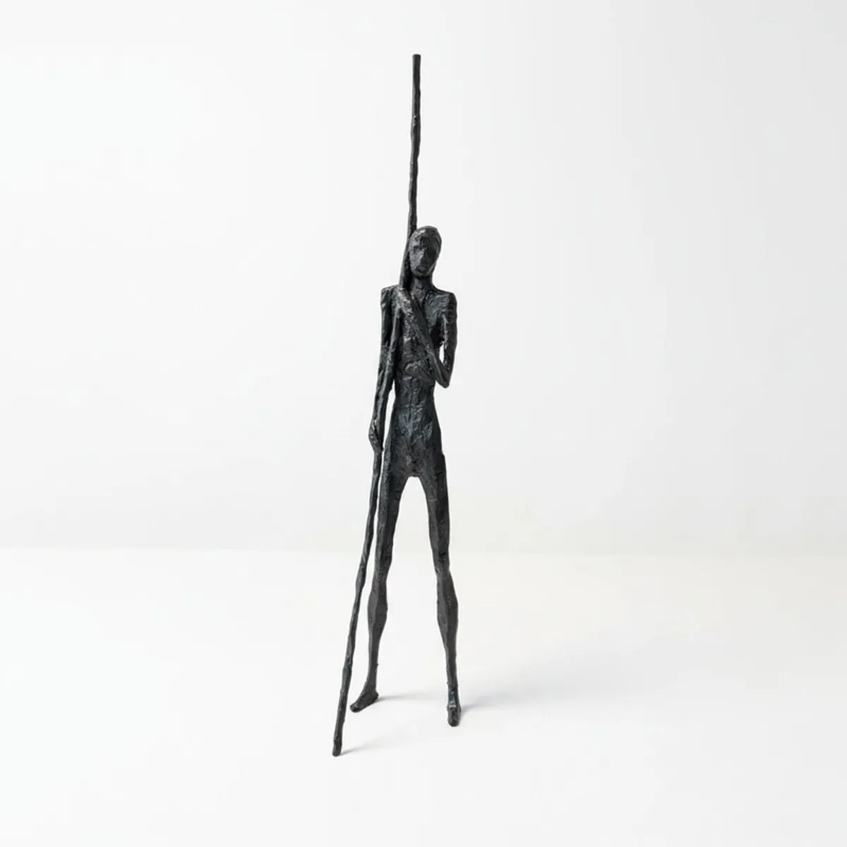 Front view of a tall black figurative cast iron showpiece