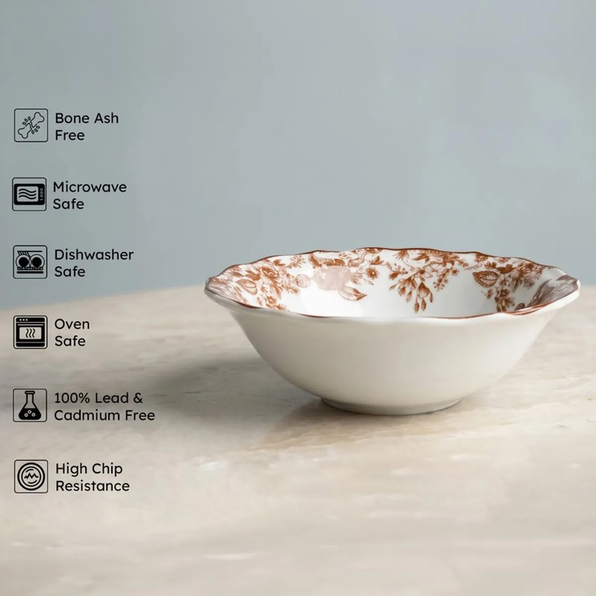 White serving bowl with red floral interior shown against a plain backdrop