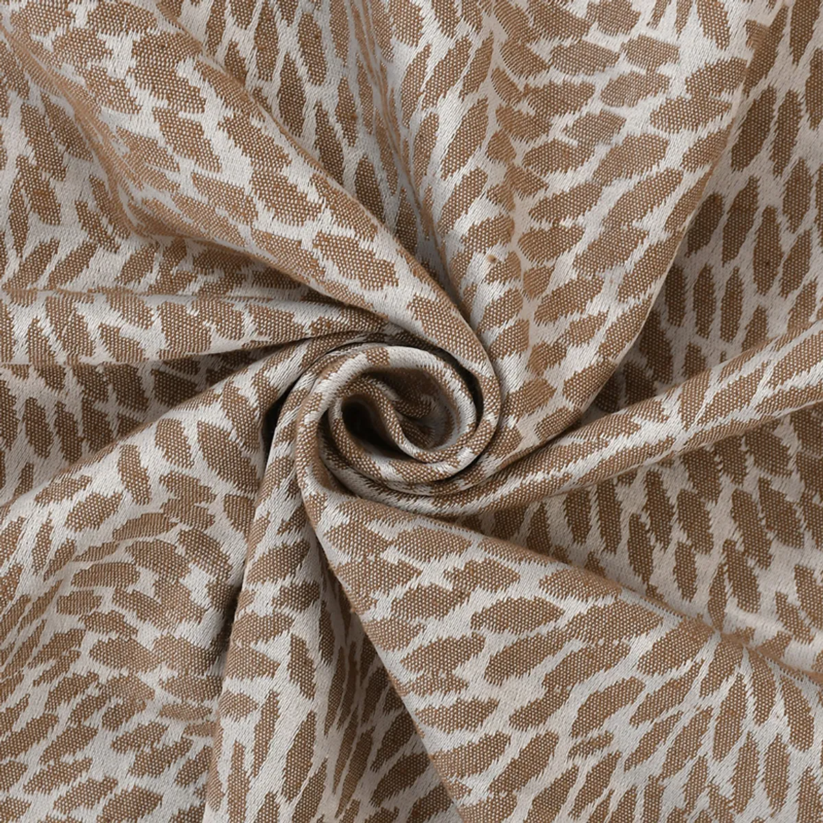 Close-up of brown and cream woven throw fabric with textured pattern