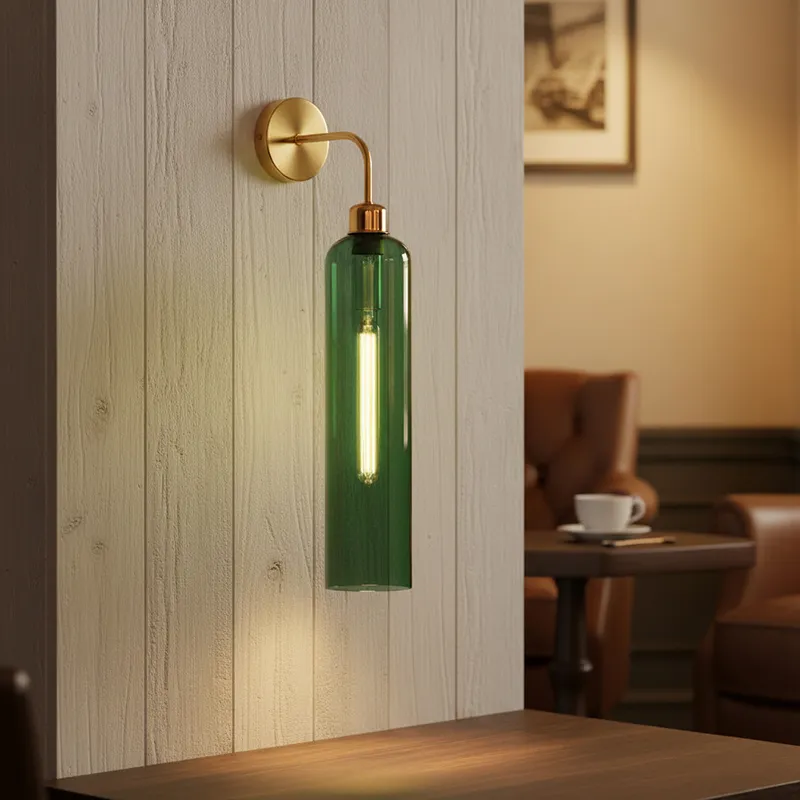 Lit green glass wall lamp with gold-toned fitting mounted on a panelled wall
