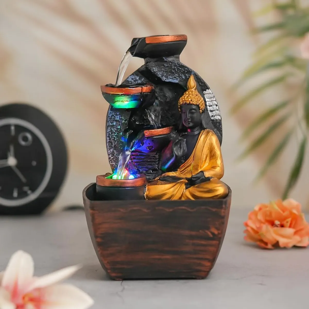 Straight-on view of Buddha tabletop fountain with cascading water and LED lights