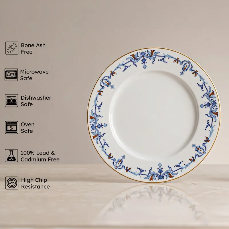 Blue and white dinner plate with ornate rim pattern shown against a plain background