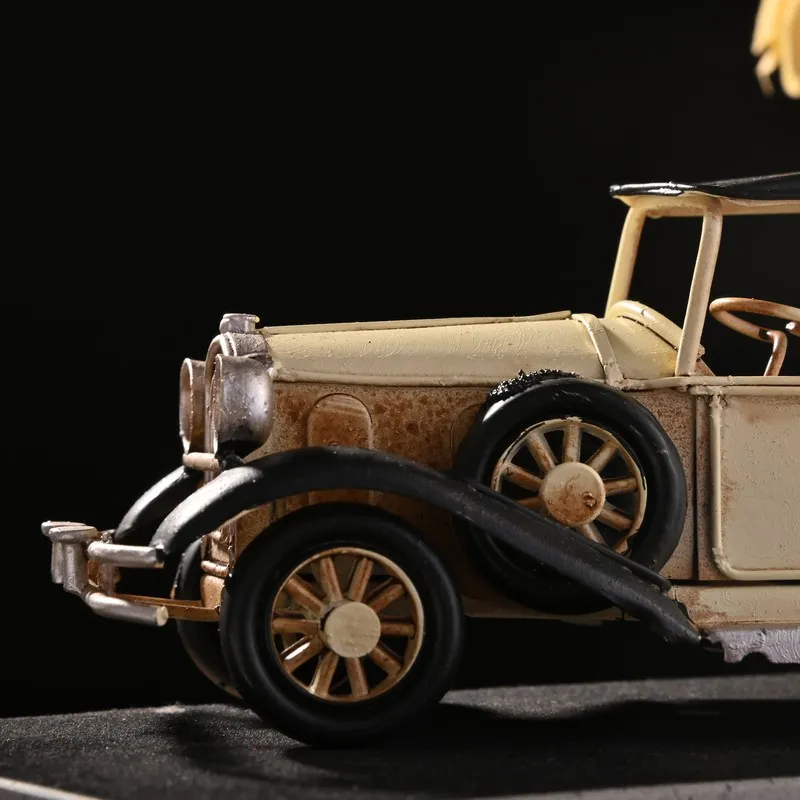 Close-up of the front side of a beige vintage model car showpiece