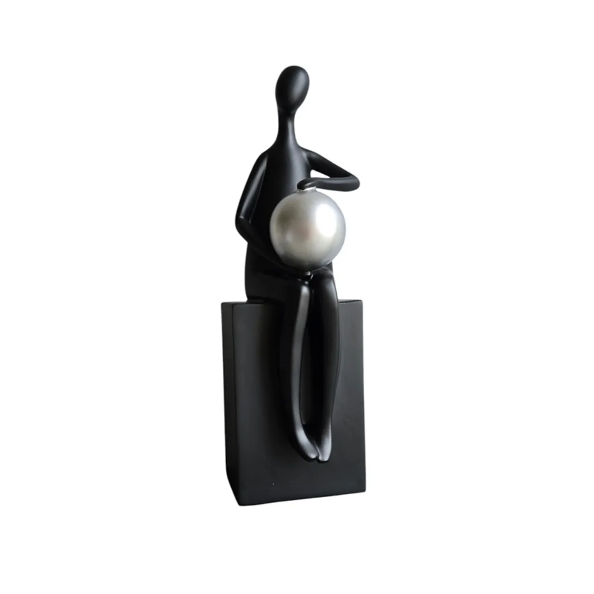 Front view of a black figurine with a silver sphere on a white background