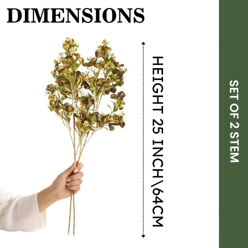 Hand holding a bunch of artificial flower stems against a plain backdrop