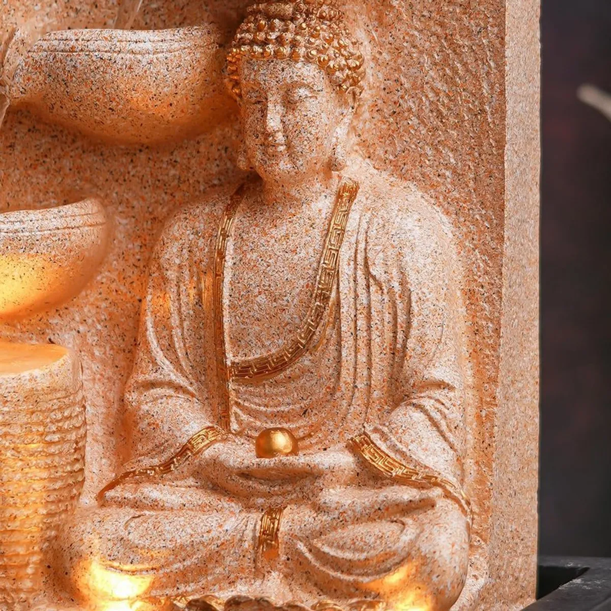 Close-up of seated Buddha figure with gold-toned detailing