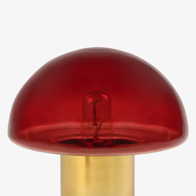 Close-up front view of the red glass mushroom lamp shade and gold base