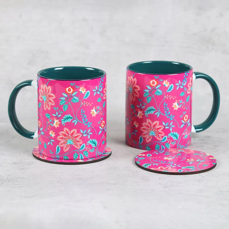 Pair of pink floral mugs with round coasters on a light surface