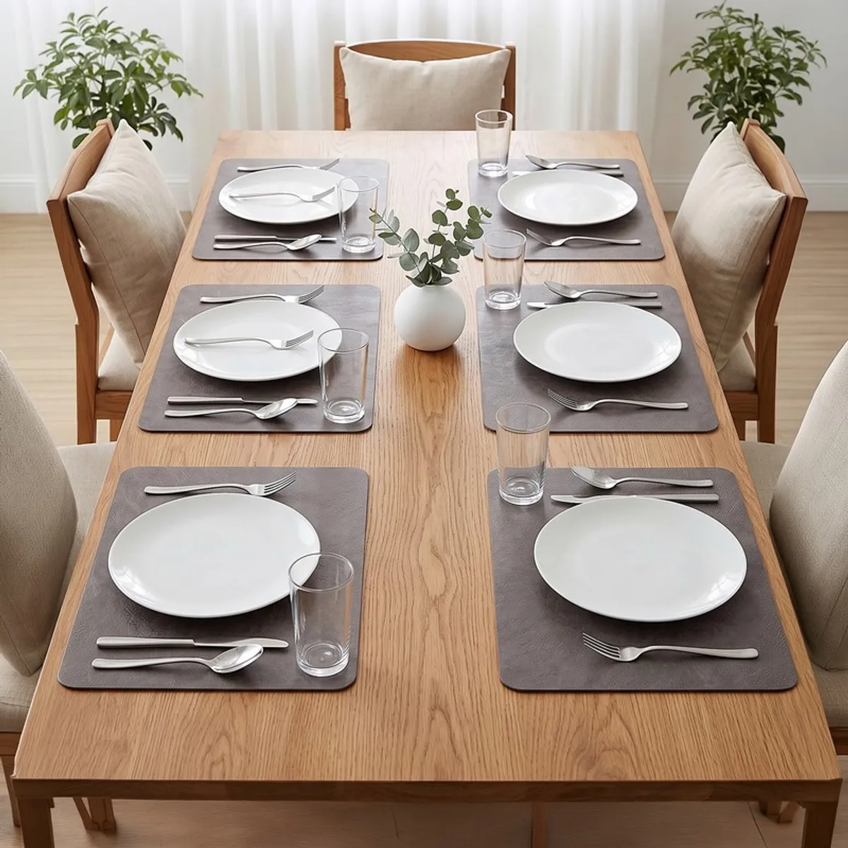 Set of six brown rectangular table mats styled on a wooden dining table