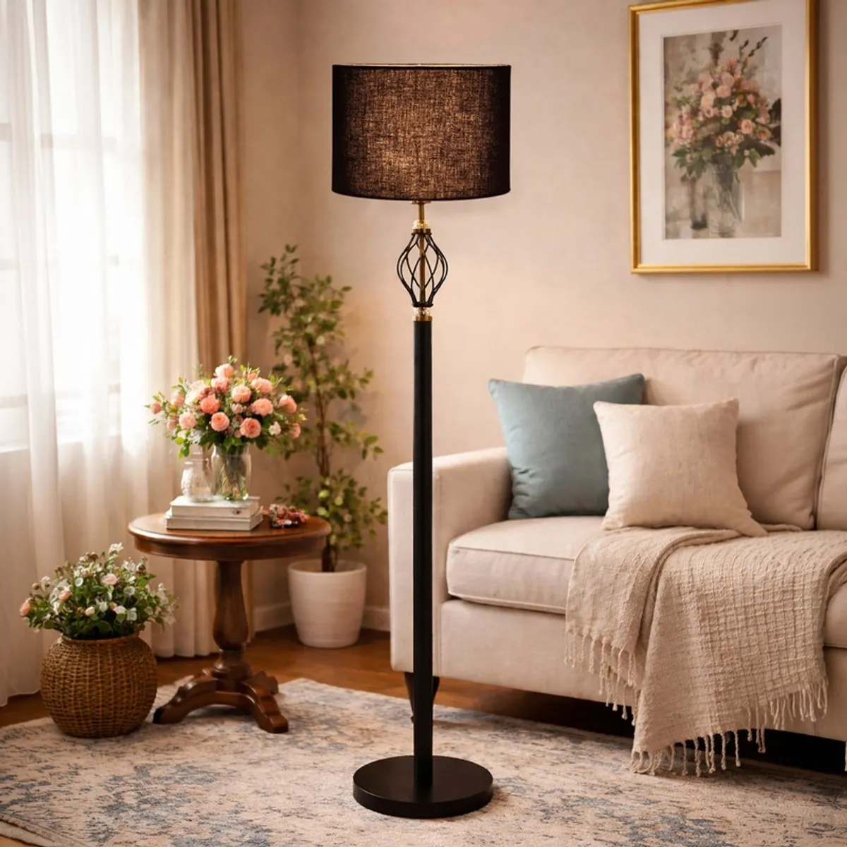 Black floor lamp styled beside a sofa with flowers and framed wall art