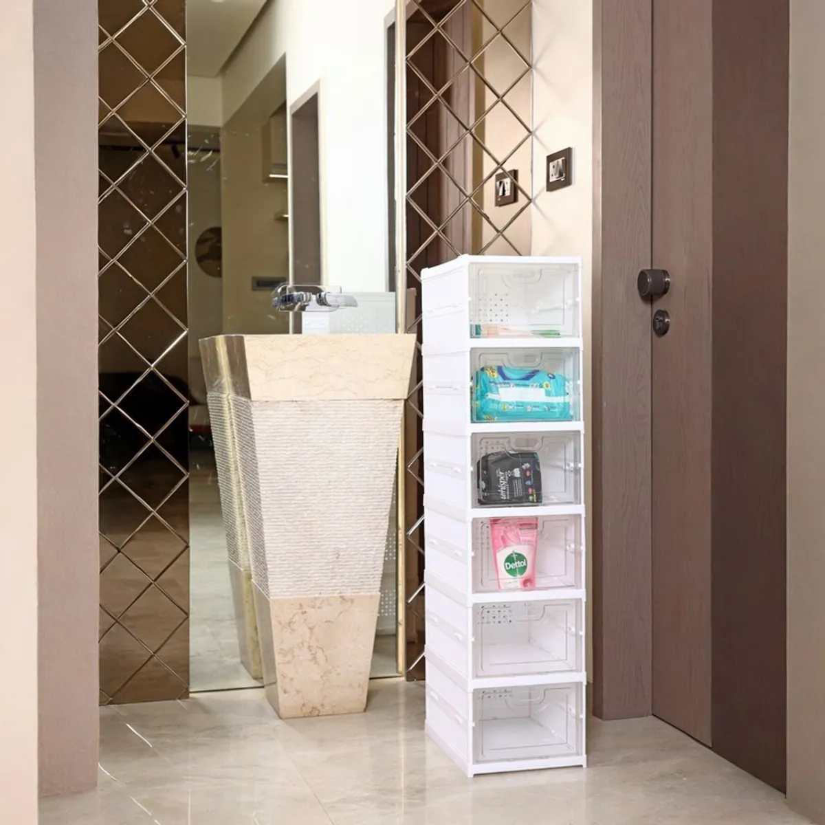 White shoe rack with transparent compartments placed beside a bathroom basin