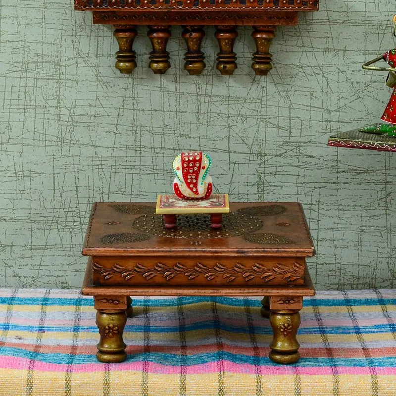 Brown wooden stool with a patterned top and turned legs in a styled room