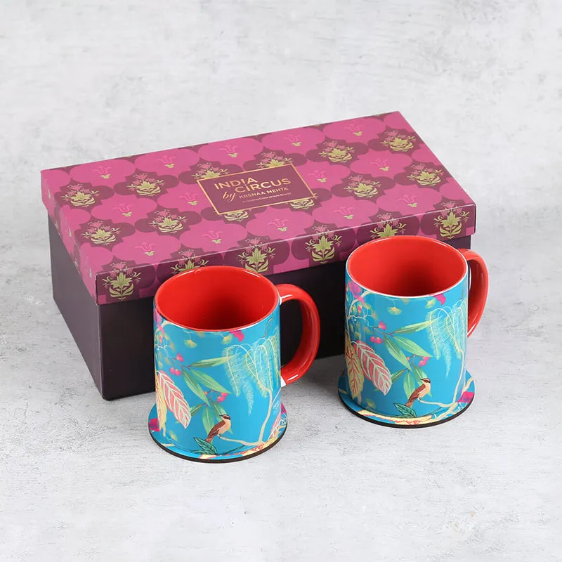 Two blue tropical ceramic mugs and coasters displayed with a patterned gift box