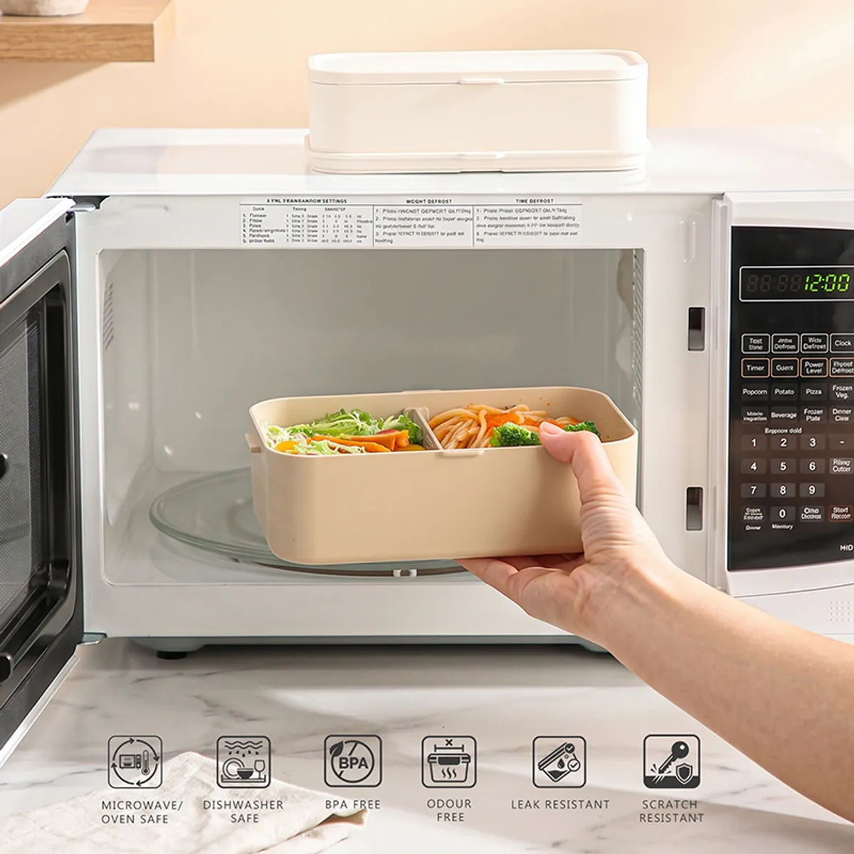 Beige lunch box being placed in a microwave for reheating