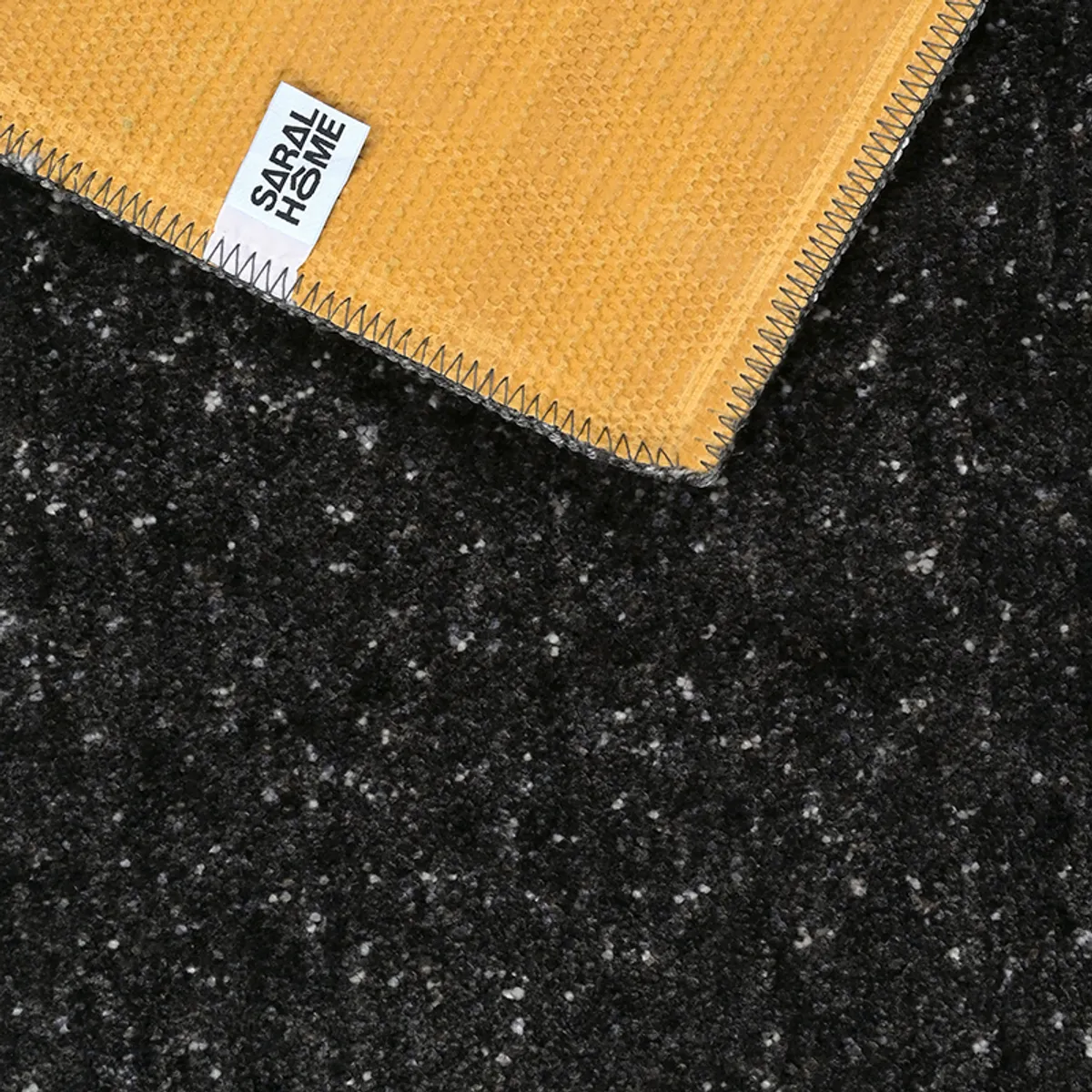 Underside of the black carpet showing its textured backing