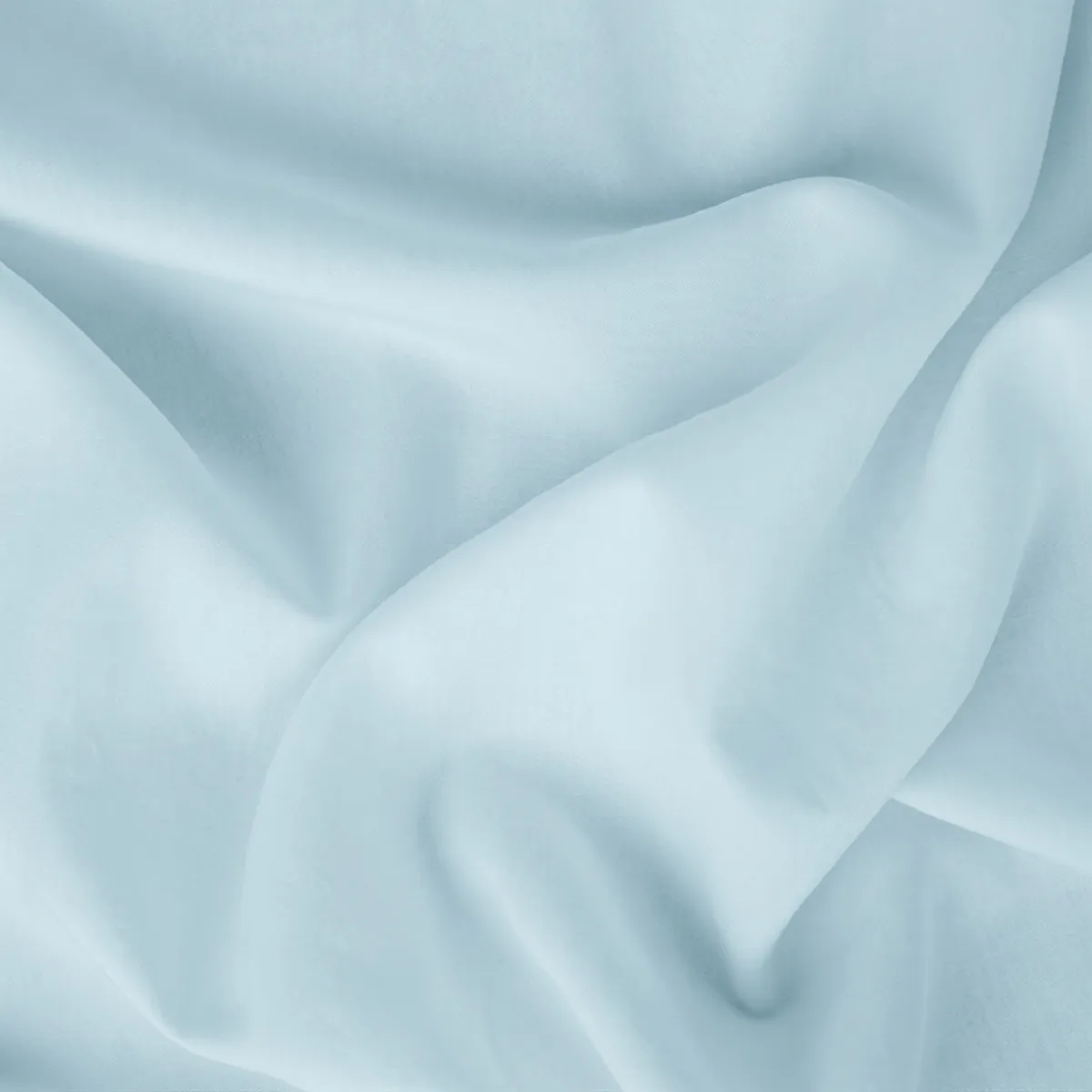 Close-up of pale blue cotton fabric with soft folds and a subtle self-design texture