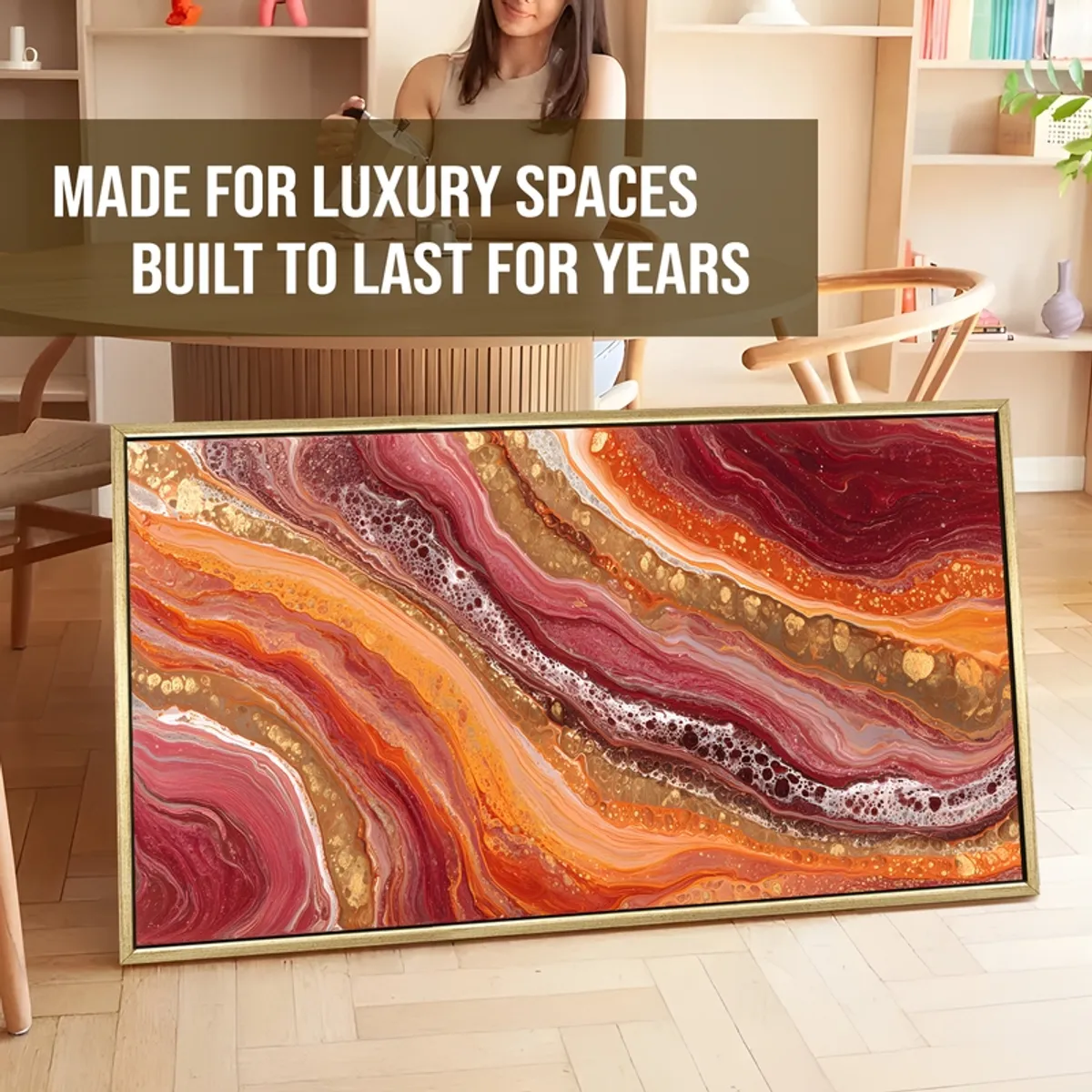 Large framed abstract canvas painting leaning against a wall in a styled room