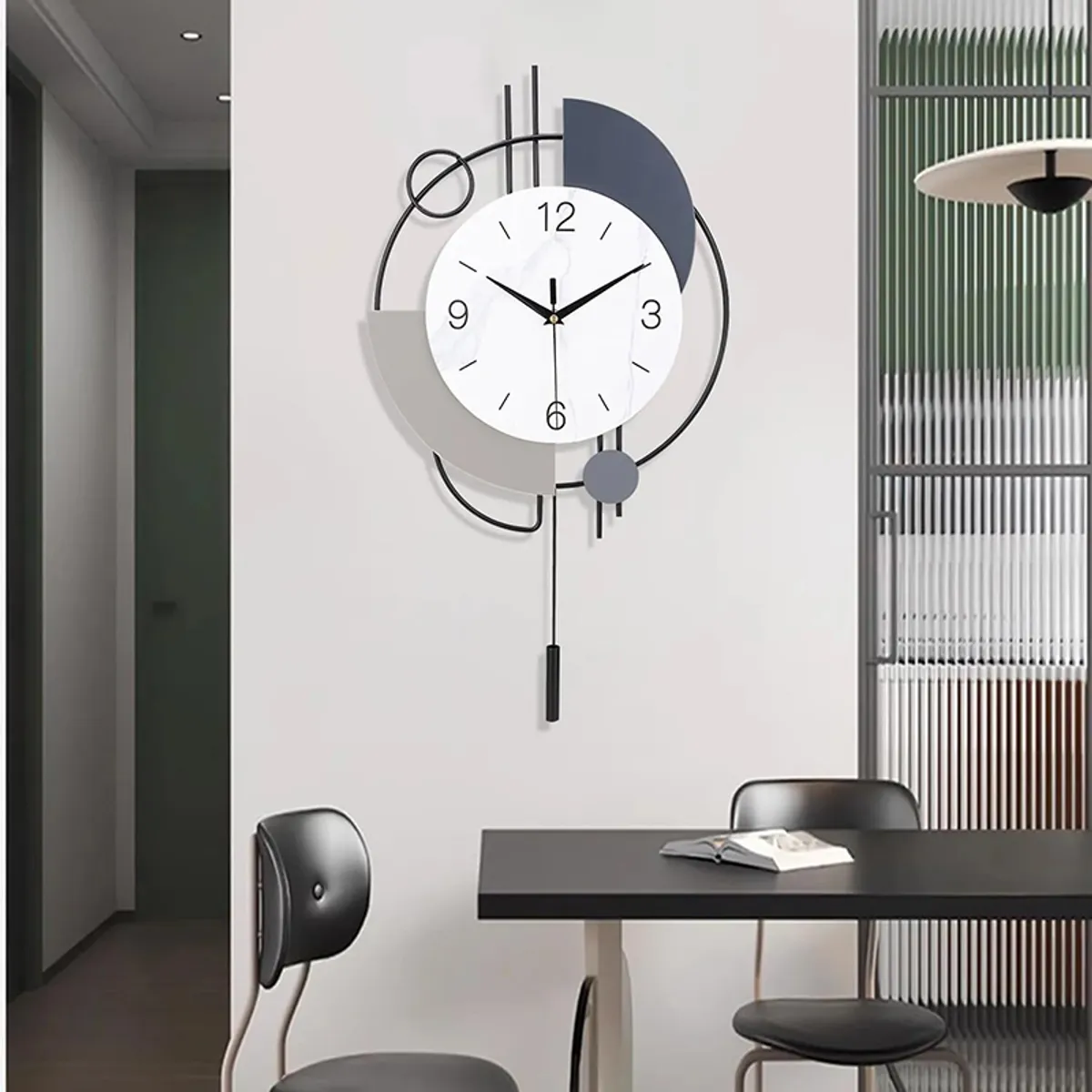 Round geometric wall clock in white, grey and black on a dining room wall