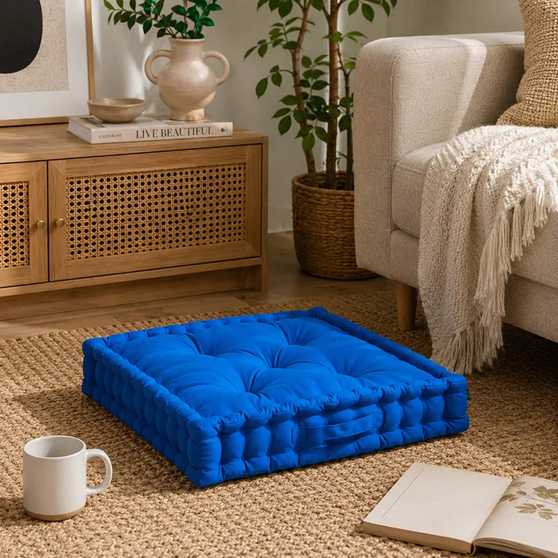 Classic blue floor cushion placed on a rug in a living room setting