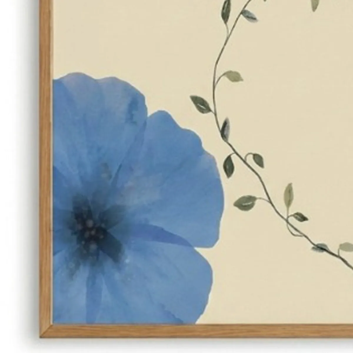 Close-up of a blue flower and leafy vine detail in a framed wall artwork