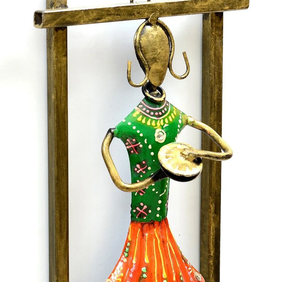 Close-up of a green and orange hand-painted musician metal wall accent