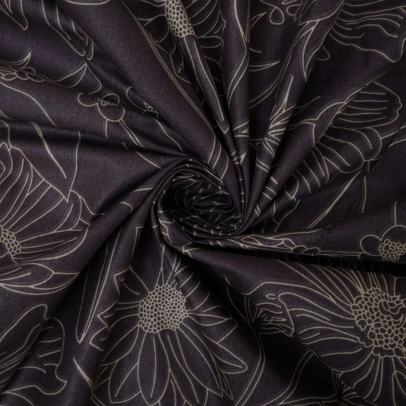 Close-up of dark purple cotton fabric with floral line pattern