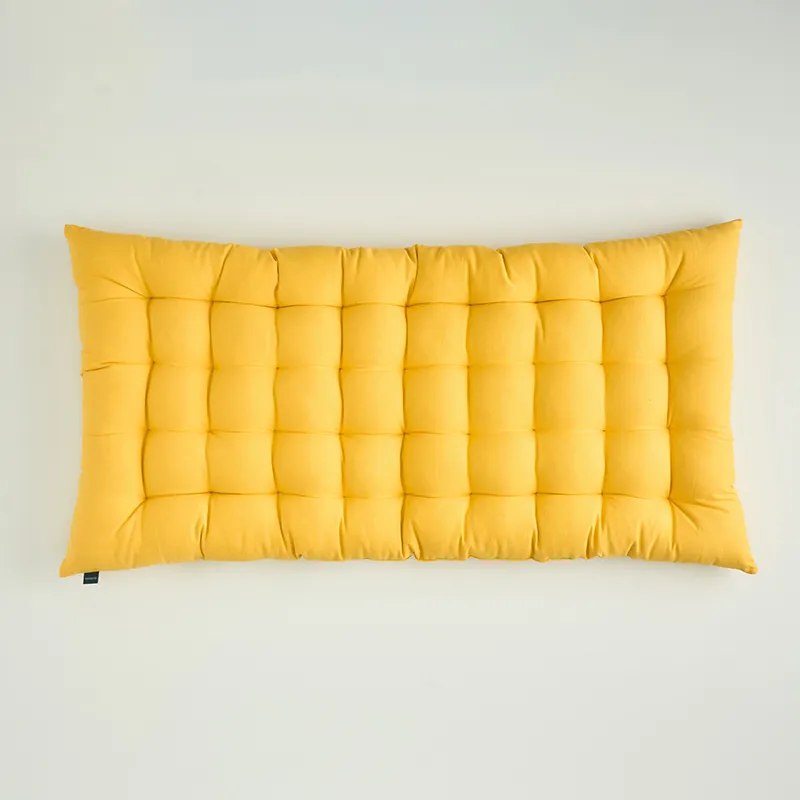 Top view of a mustard yellow rectangular tufted floor cushion