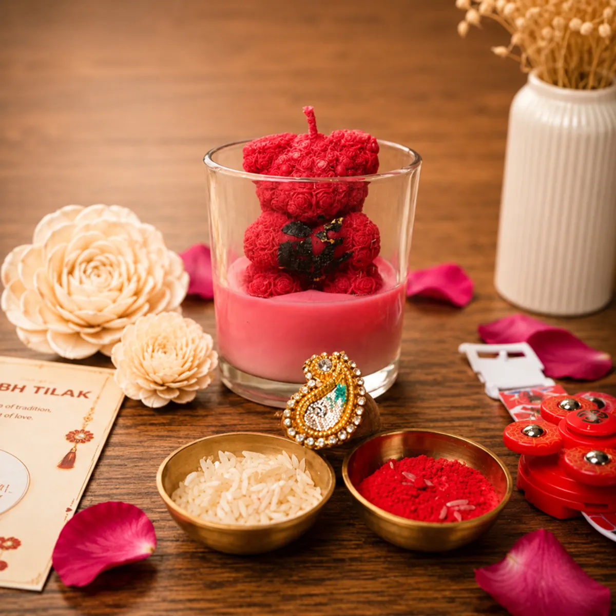Close-up of red teddy candle with gola, roli, chawal and festive card