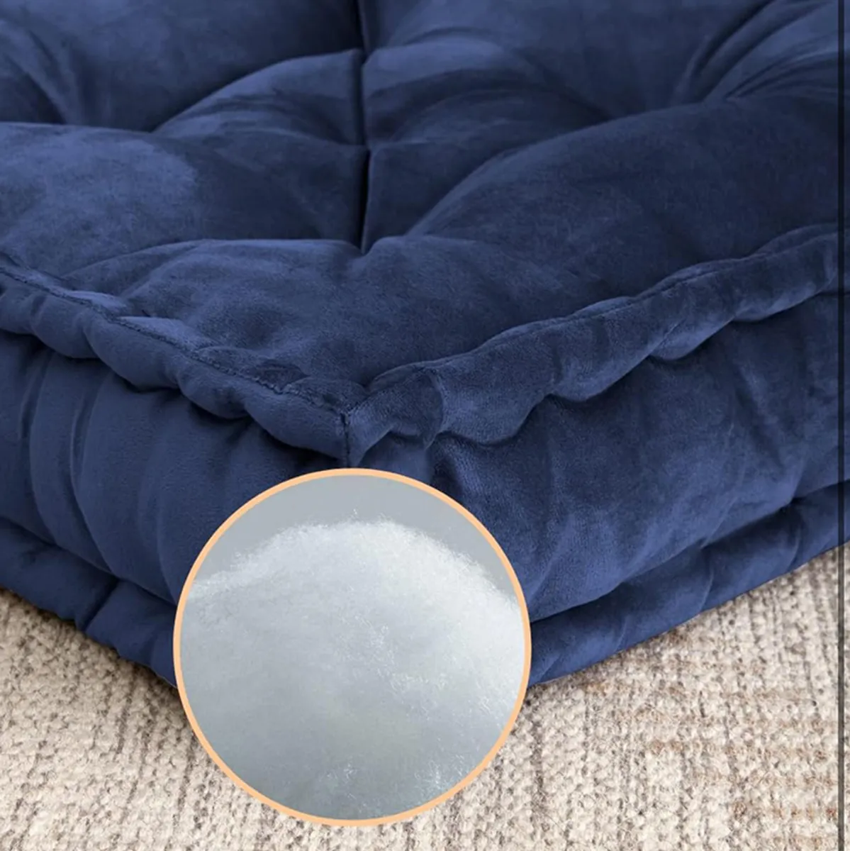Close-up showing the plush tufted navy velvet cushion texture