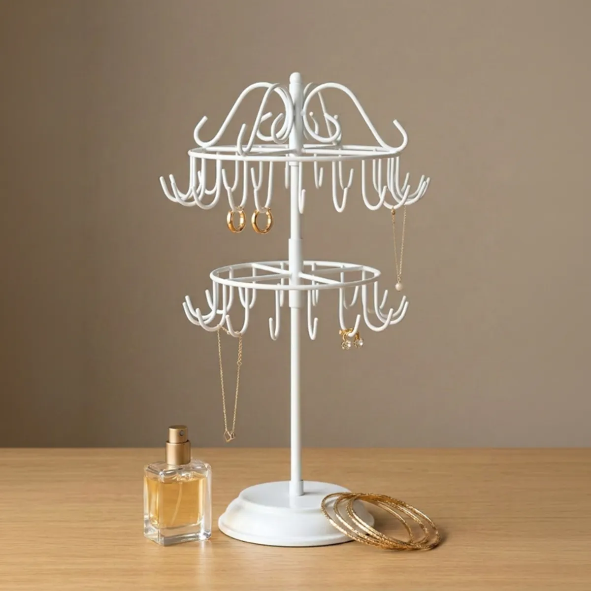 White metal jewellery stand with curved hooks and two circular tiers
