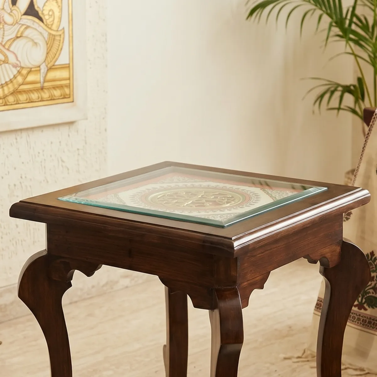Close view of brown side table with glossy square top and curved legs