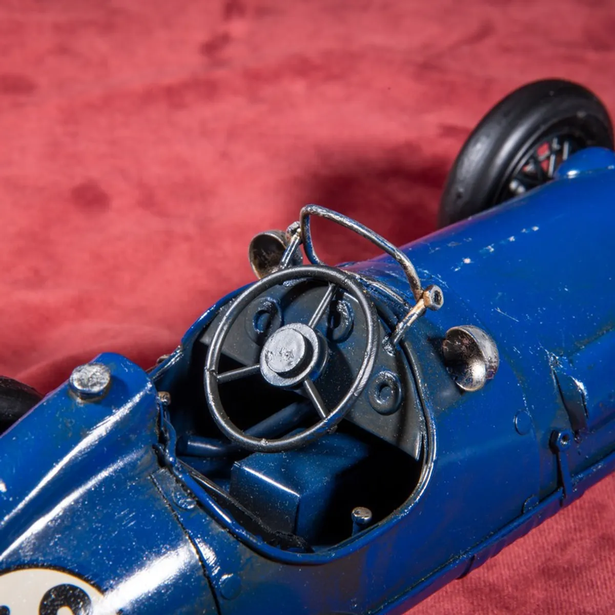 Close-up of cockpit and steering detail on blue racing car showpiece