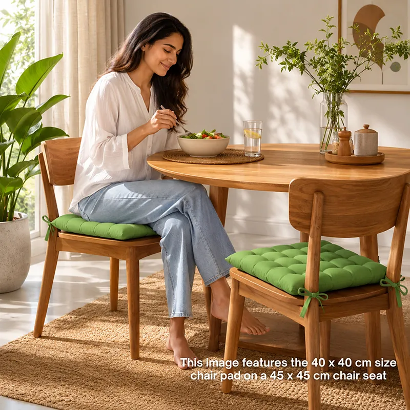 Green chair pads styled on wooden dining chairs in a bright dining room