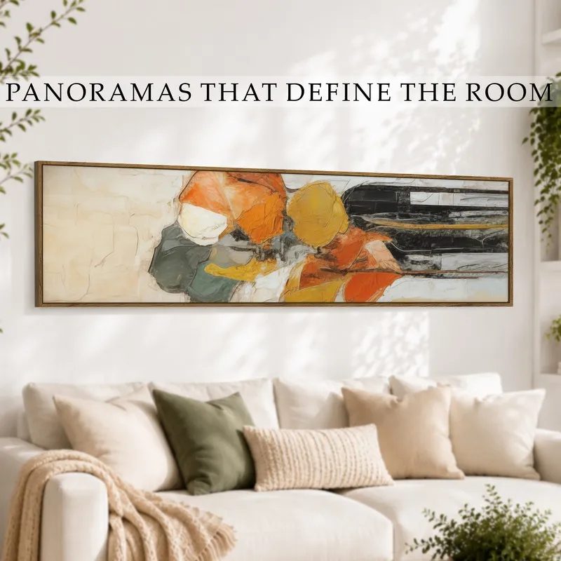 Framed rectangular abstract wall art in orange, yellow and black over a cream sofa