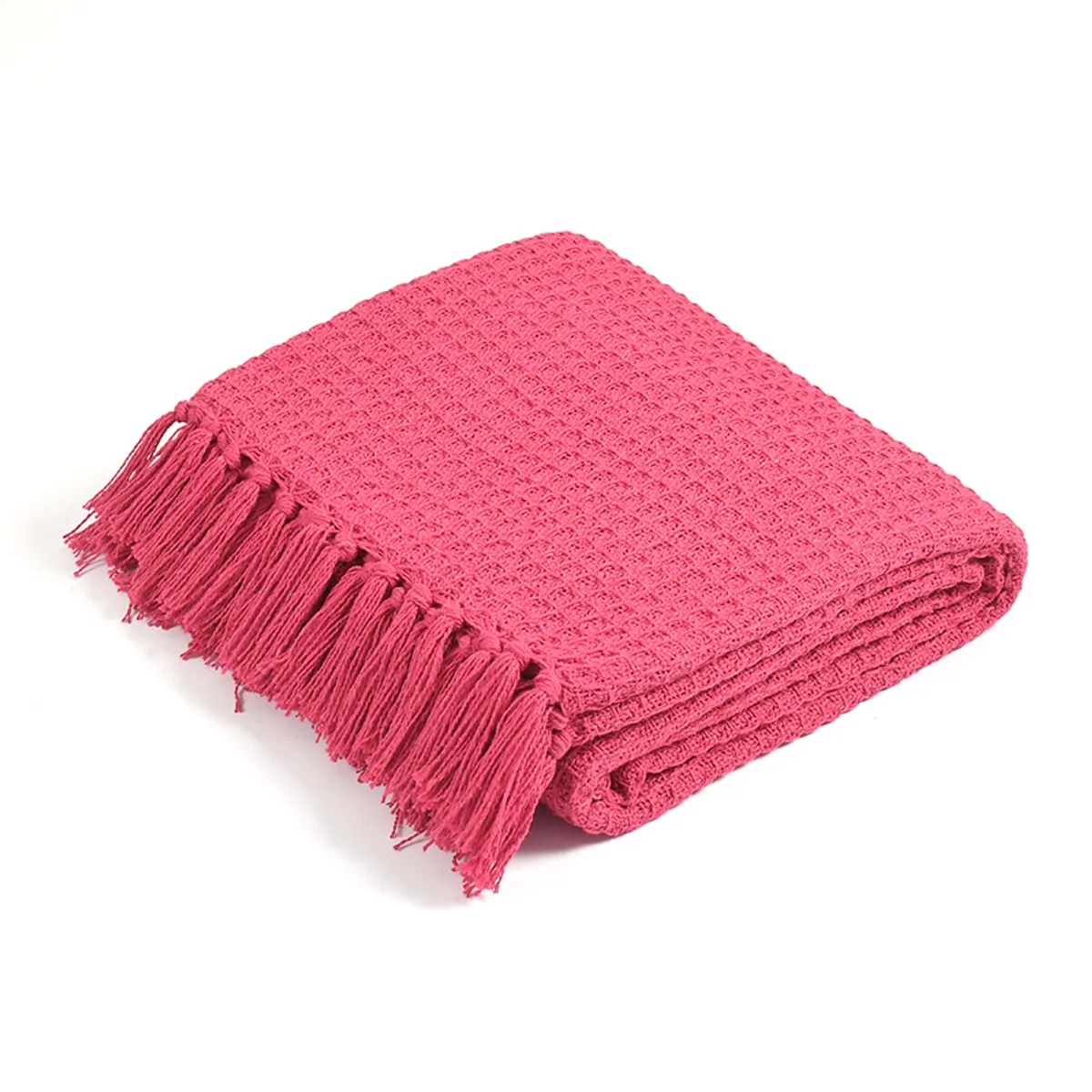 Folded bright pink waffle throw with tasselled fringe