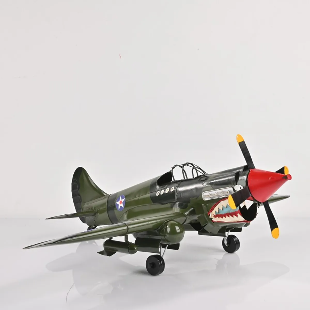 Front side view of vintage aircraft tabletop showpiece on a white background
