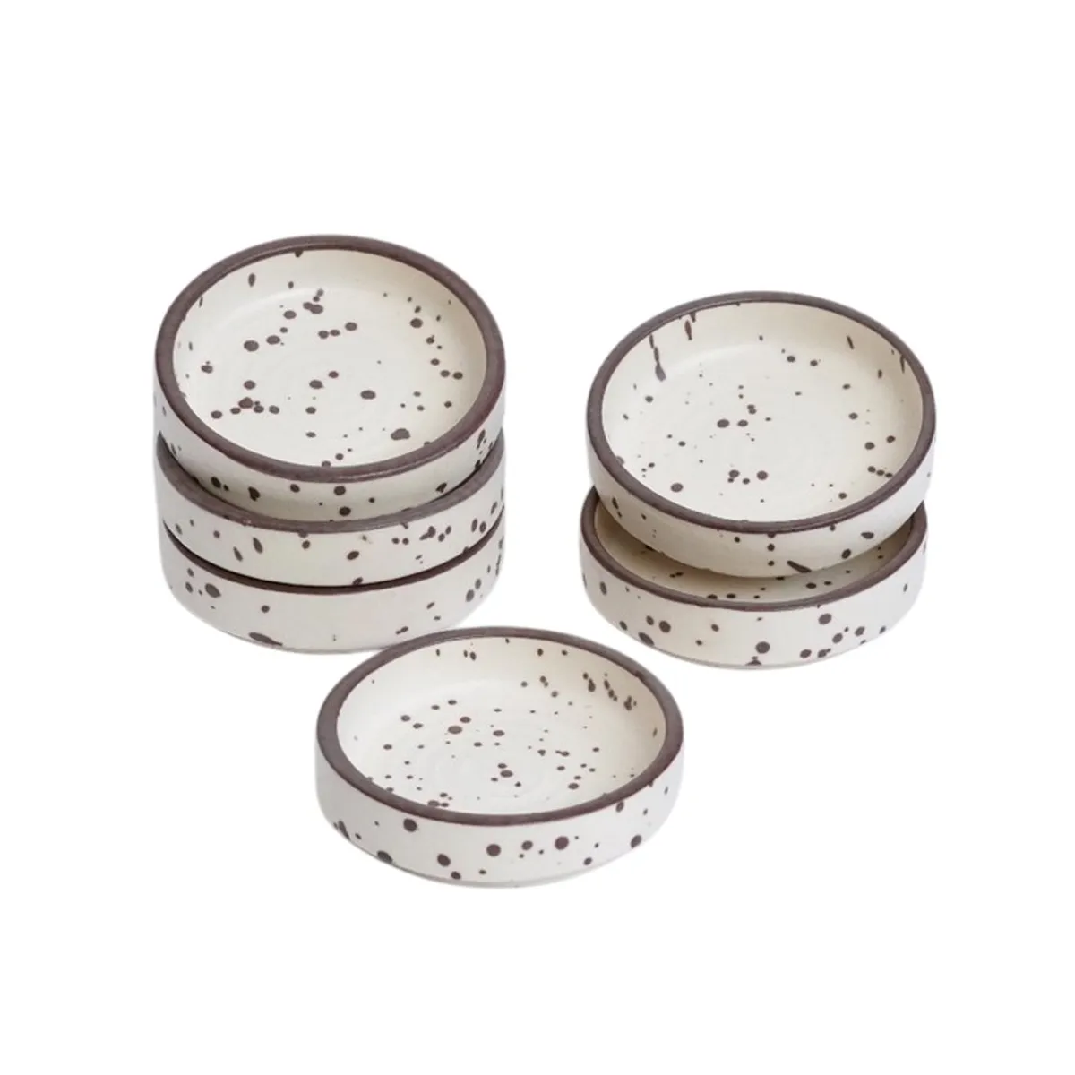 Stacked white speckled ceramic dip bowls with dark rims