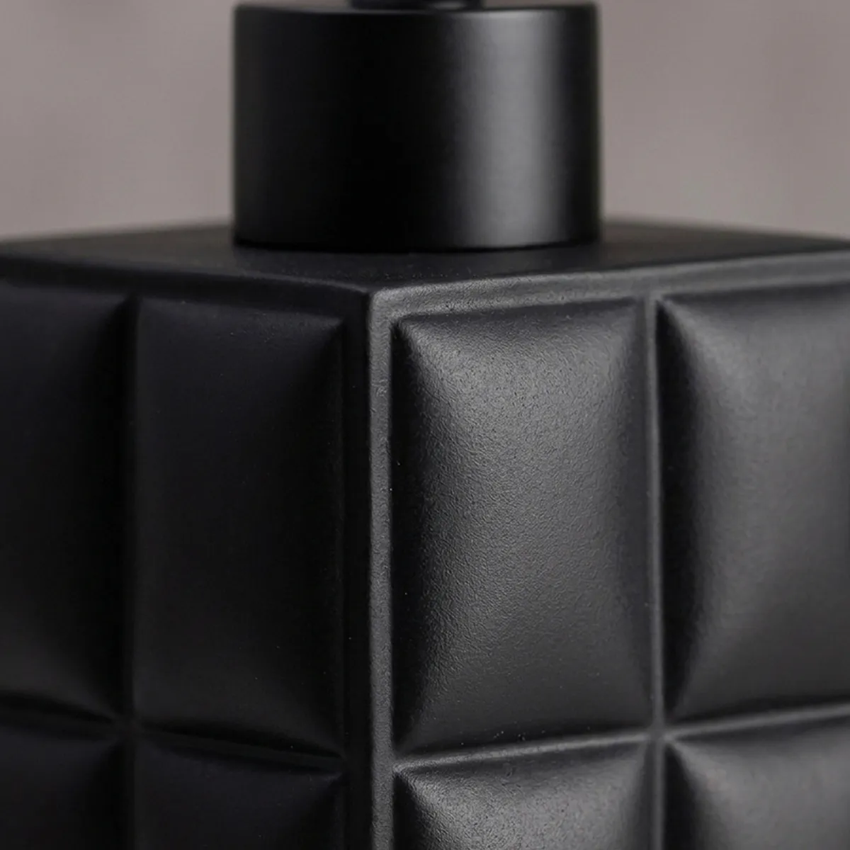 Close-up of the matte black textured surface on the soap dispenser