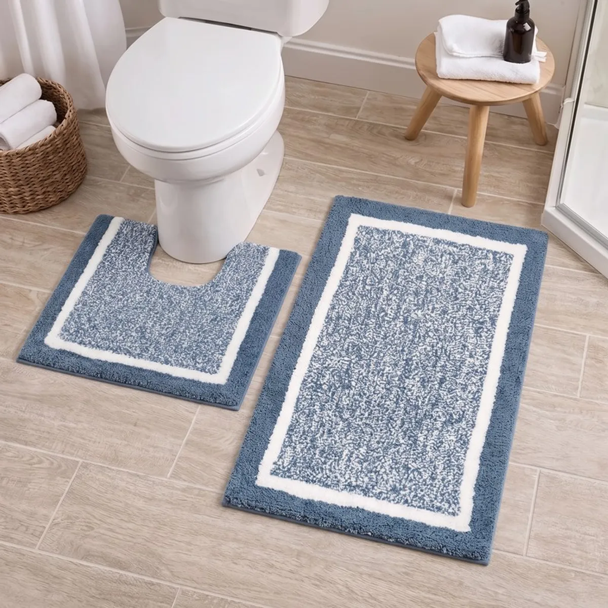 Blue and white geometric bath mats arranged around a toilet