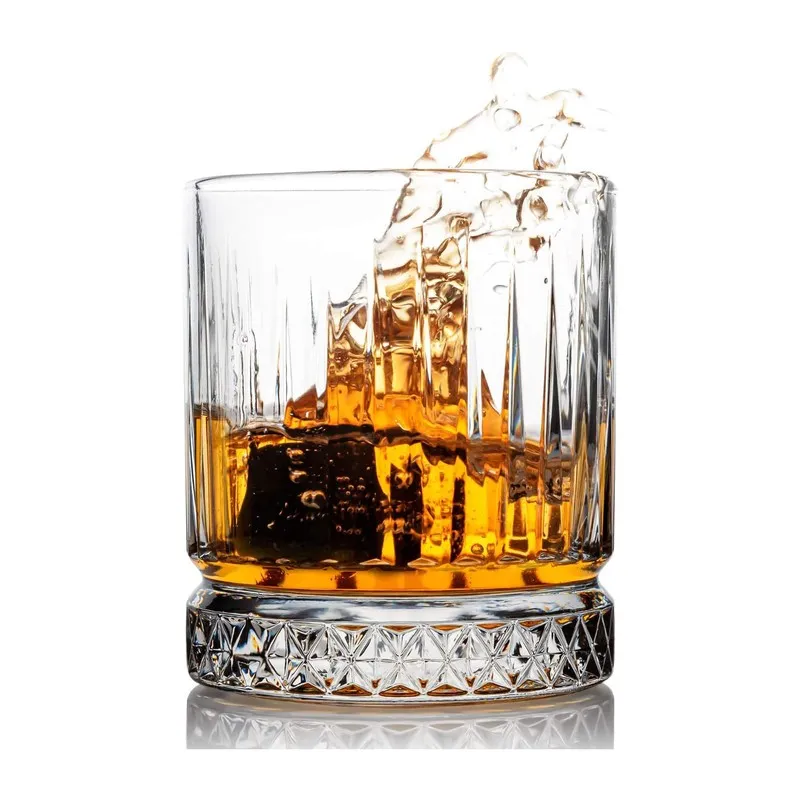 Single clear whiskey glass with vertical texture and patterned base