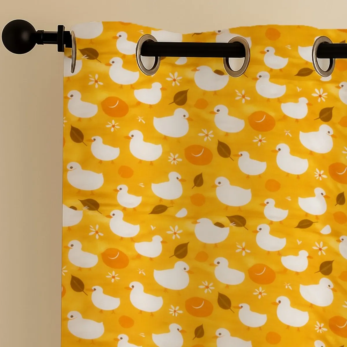 Close-up of eyelet heading and white duck print on yellow curtain