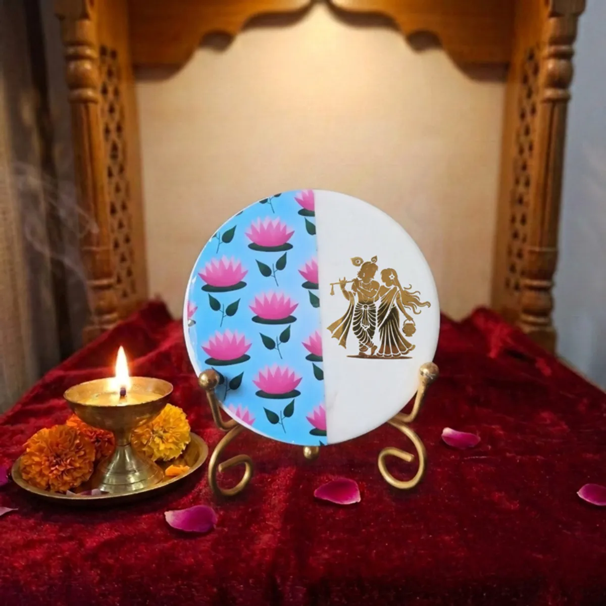 Round marble showpiece on a gold stand styled on a red altar cloth beside a lamp
