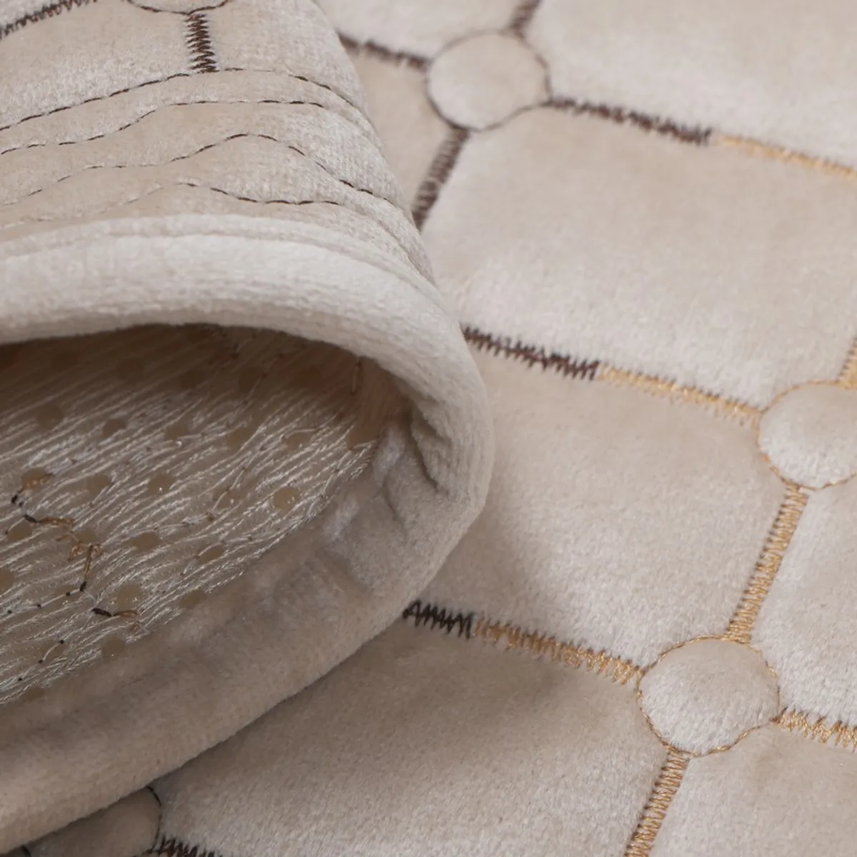 Close-up of the beige cover's soft edge and textured geometric surface