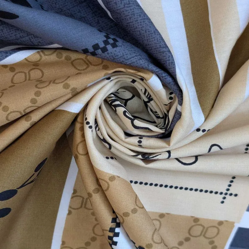 Close-up of the printed cotton fabric in brown, navy and cream tones